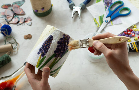 Dekorieren von Blechdosen mit Decoupage-Servietten, Juteseil und verschiedenen Dekoelementen.